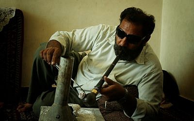An Iranian man smoking opium in Kerman, Iran. (CC BY-SA hypertornado, Flickr)