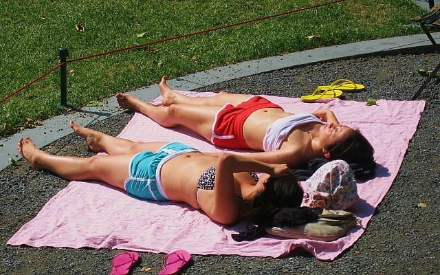 Sunbathers in a New York park, in May 2012 (photo credit: CC-BY-SA, JMazzolaa, Flickr)