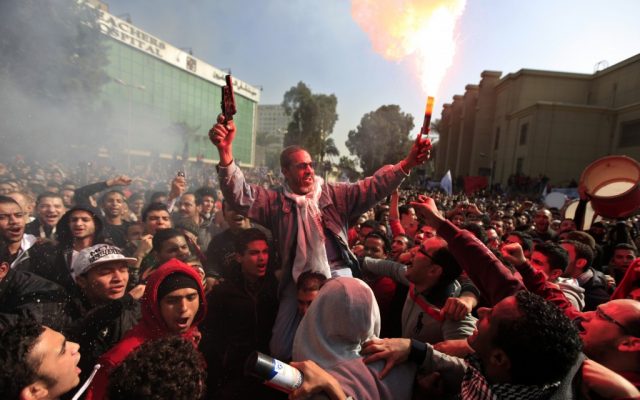 Egyptian soccer fans of Al-Ahly club celebrate a court verdict that returned 21 death penalties in last years soccer violence, inside the club premises in Cairo, Egypt, on Saturday, January 26, 2013. (photo credit: AP Photo/Khalil Hamra) Egyptian soccer fans of Al-Ahly club celebrate a court verdict that returned 21 death penalties in last years soccer violence, inside the club premises in Cairo, Egypt, on Saturday, January 26, 2013. (photo credit: AP Photo/Khalil Hamra)