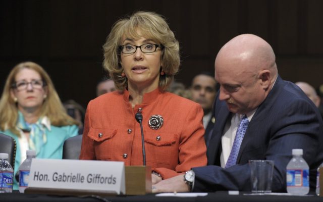 Former Arizona Rep. Gabrielle Giffords, who was seriously injured in the mass shooting that killed six people in Tucson, Ariz. two years ago, sits with her husband Mark Kelly, and speaks on Capitol Hill in Washington, Wednesday, Jan. 30, 2013, before the Senate Judiciary Committee hearing on gun violence. (photo credit: AP/Susan Walsh)