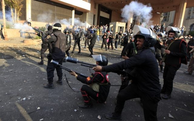 Egyptian riot police fire tear gas at unseen protesters during clashes in front of the Semiramis Intercontinental Hotel, near Tahrir Square, Cairo, Egypt, Tuesday, January 29, 2013. (photo credit: AP/Khalil Hamra)