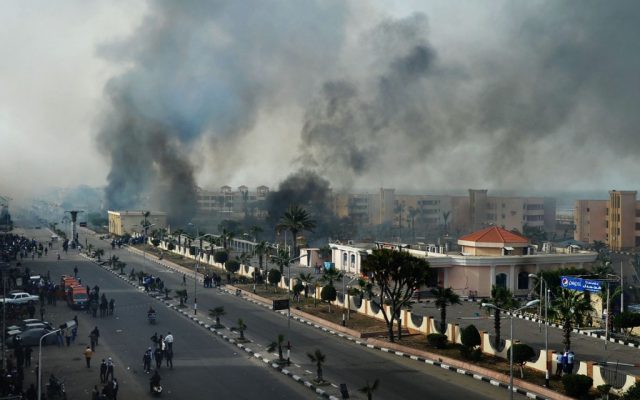 Smoke rises after Egyptian protesters clash with police in Port Said, Egypt, Sunday (photo credit: AP) Smoke rises after Egyptian protesters clash with police in Port Said, Egypt, Sunday (photo credit: AP)