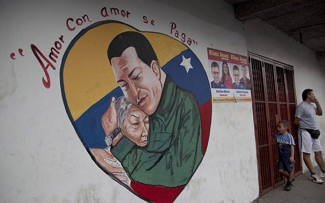 A heart-shaped mural shows an image of Venezuela's President Hugo Chavez hugging a woman. Chavez hasn't spoken publicly or been seen since his Dec. 11 operation in Cuba, and the latest report from his government Thursday night increased speculation that he is unlikely to attend his Jan. 10 inaugural ceremony. The message above the mural reads in Spanish; "Love is repaid with love." (AP Photo/Ariana Cubillos) A heart-shaped mural shows an image of Venezuela's President Hugo Chavez hugging a woman. Chavez hasn't spoken publicly or been seen since his Dec. 11 operation in Cuba, and the latest report from his government Thursday night increased speculation that he is unlikely to attend his Jan. 10 inaugural ceremony. The message above the mural reads in Spanish; "Love is repaid with love." (AP Photo/Ariana Cubillos)