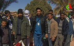 Unidentified rescued hostages pose for media in Ain Amenas, Algeria, in this image taken from television, January 2013 (photo credit: AP/Canal Algerie via Associated Press TV)