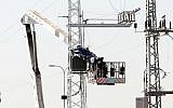 Israel Electric Company workers build a new electric line (Photo credit: Roni Schutzer/Flash 90)