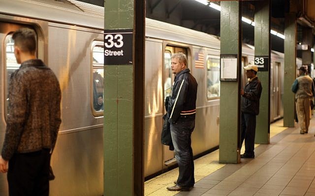 People stand on a platform waiting to get on the subway in New York City (photo credit: Kobi Gideon/Flash90) People stand on a platform waiting to get on the subway in New York City (photo credit: Kobi Gideon/Flash90)