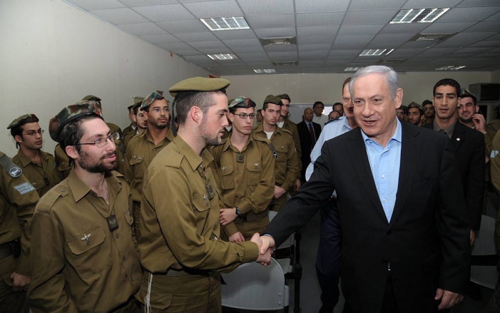 Prime Minister Benjamin Netanyahu speaks with soldiers serving in the IDF's religious unit. (photo credit: Amos BenGershom/GPO/Flash90)