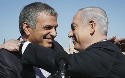 Prime Minister Benjamin Netanyahu embraces then-communications and welfare minister Moshe Kahlon, during a press conference on January 21, 2013. (photo credit: Miriam Alster/Flash90)