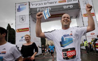 Mayor of a 'normal' city: Nir Barkat finishes the half-marathon, during the International Jerusalem Marathon in March 2013. (photo credit: Miriam Alster/Flash90)