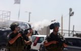 Israeli security personnel fire tear gas at Palestinian protesters, August, 2012. (photo credit: Issam Rimawi/Flash90)