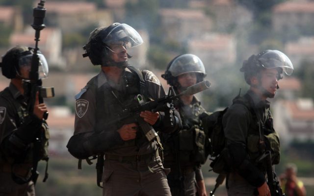 An Israeli soldier firing a tear gas cannister during a demonstration in the West Bank in October 2012. (photo credit: Issam Rimawi/Flash90) An Israeli soldier firing a tear gas cannister during a demonstration in the West Bank in October 2012. (photo credit: Issam Rimawi/Flash90)