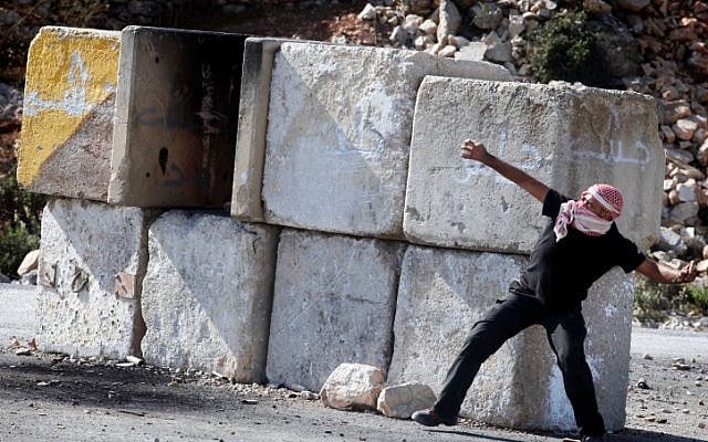 Palestinian protesters throw stones at Israeli security forces, November, 2012. (photo credit: Issam Rimawi/FLASH90)