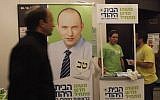 A man walking by a booth for Jewish Home in Jerusalem in December. (photo credit: Miriam Alster/Flash90)
