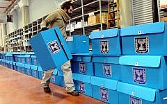 A worker on Tuesday prepares ballot boxes for the January 22 elections at a warehouse in Shoham, near Tel Aviv, before they are shipped to polling stations. (photo credit: Yossi Zeliger/Flash90)
