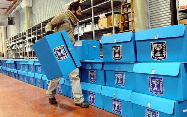 A worker on Tuesday prepares ballot boxes for the January 22 elections at a warehouse in Shoham, near Tel Aviv, before they are shipped to polling stations. (photo credit: Yossi Zeliger/Flash90)