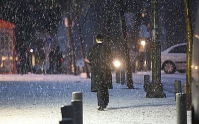 An ultra-Orthodox jewish man walks in the snow on a Jerusalem street, Wednesday, January 9, 2013 (photo credit: Yonatan Sindel/Flash90)
