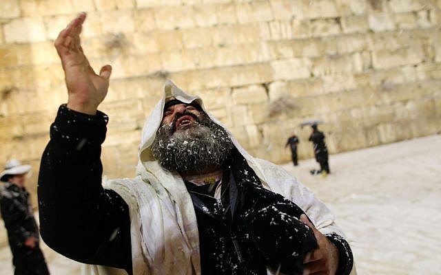 A man at the Western Wall, perhaps praying for rain of the non-freezing variety. (photo credit: Nati Shohat/Flash90) A man at the Western Wall, perhaps praying for rain of the non-freezing variety. (photo credit: Nati Shohat/Flash90)
