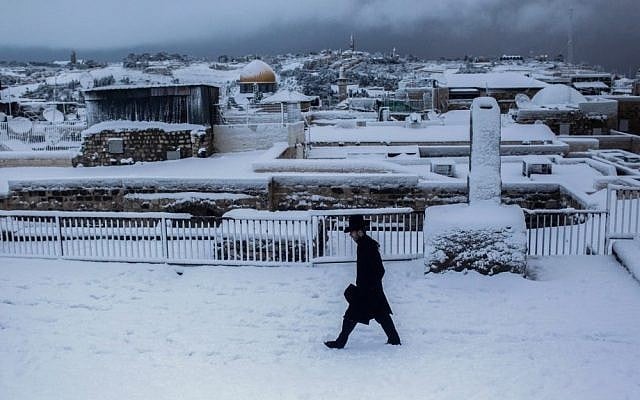 The Dome of the Rock is seen in the background as an ultra-Orthodox man walks along the rooftops in Jerusalem's Old City on Thursday (photo credit: Yonatan Sindel/Flash90)