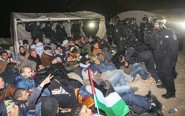 Israeli Border Police remove a Palestinian from an outpost of tents in an area known as E1, near Jerusalem, January 13, 2013. (photo credit: Flash90) Israeli Border Police remove a Palestinian from an outpost of tents in an area known as E1, near Jerusalem, January 13, 2013. (photo credit: Flash90)
