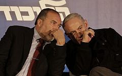 Avigdor Liberman (left), and Benjamin Netanyahu sharing a private word in January 2013. (Tsafrir Abayov/Flash90)