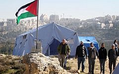 Palestinian protestors gather next to tents erected near the West Bank village of Beit Iksa, between Ramallah and Jerusalem, on Sunday (photo credit: Issam Rimawi/Flash90)