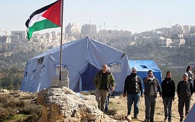 Palestinian protestors gather next to tents erected near the West Bank village of Beit Iksa, between Ramallah and Jerusalem, on Sunday (photo credit: Issam Rimawi/Flash90)
