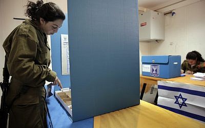 A soldier votes on a small army base along the border with the West Bank near Shekef, Israel, Monday, Jan. 21, 2013. (photo credit: Tsafrir Abayov/Flash90)
