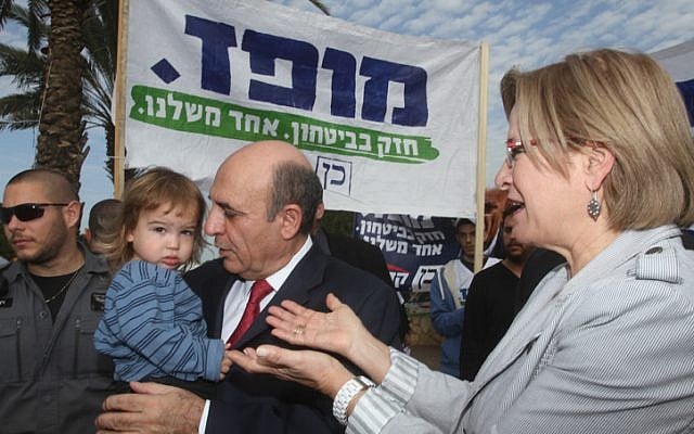 Kadima chairman Shaul Mofaz and his wife arrive at a polling station in Kohav Yair to cast their votes on Tuesday, January 22 (photo credit: Flash90) Kadima chairman Shaul Mofaz and his wife arrive at a polling station in Kohav Yair to cast their votes on Tuesday, January 22 (photo credit: Flash90)
