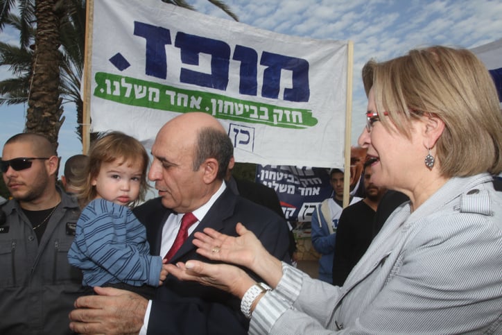 Kadima chairman Shaul Mofaz and his wife arrive at a polling station in Kohav Yair to cast their votes on Tuesday, January 22 (photo credit: Flash90) Kadima chairman Shaul Mofaz and his wife arrive at a polling station in Kohav Yair to cast their votes on Tuesday, January 22 (photo credit: Flash90)