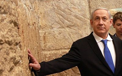 Prime Minister Benjamin Netanyahu goes to the Western Wall after casting his vote (Photo credit: Marc Israel Sellem/POOL/FLASH90) Prime Minister Benjamin Netanyahu goes to the Western Wall after casting his vote (Photo credit: Marc Israel Sellem/POOL/FLASH90)