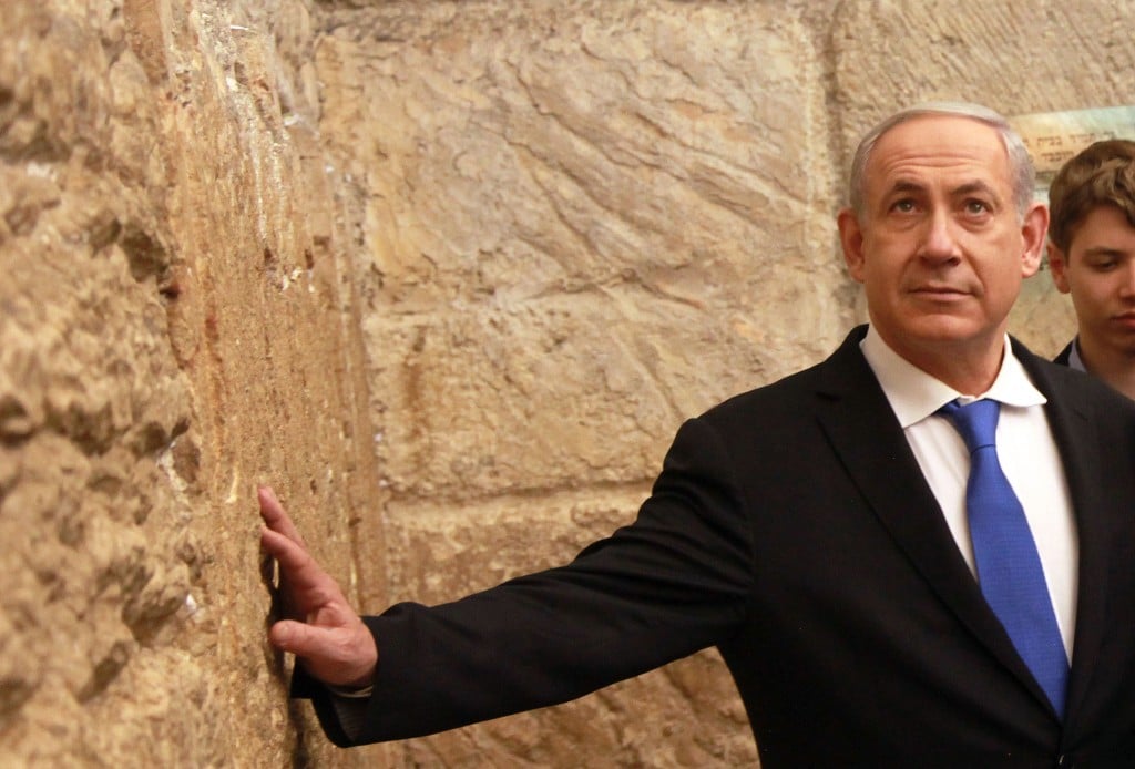 Prime Minister Benjamin Netanyahu goes to the Western Wall after casting his vote (Photo credit: Marc Israel Sellem/POOL/FLASH90)