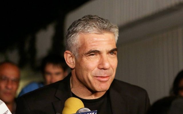 Yesh Atid leader Yair Lapid speaks to the press outside his home in Tel Aviv on Wednesday (photo credit: Flash90)