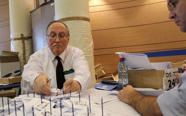 Judge Elyakim Rubinstein, head of the Central Election Committee, tallying votes in Jerusalem on Tuesday. (photo credit:  Miriam Alster/Flash90)