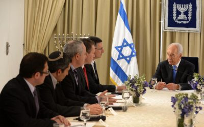 President Shimon Peres sits next to representatives of the Likud-Beytenu faction in Jerusalem, January 30 2013. (photo credit: Mark Nayman/GPO/Flash90)