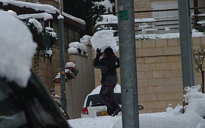 Is that a snowman abdomen or a really badass snowball? A man conducts a delivery in Jerusalem, Thursday (photo credit: Daniel Laufer)