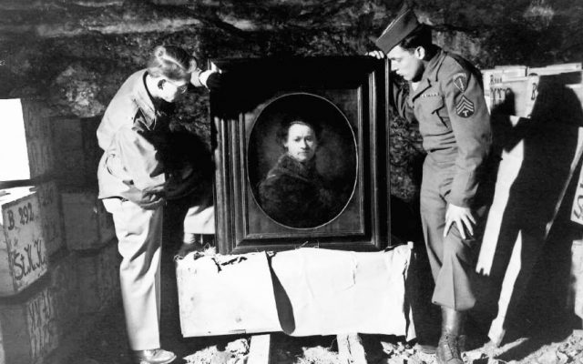 Two US soldiers, shown in 1945 or 1946 inspecting a Rembrandt self-portrait in a salt mine where the Nazis stored stolen and hidden art. (photo credit: Courtesy National Archives and Records Administration)