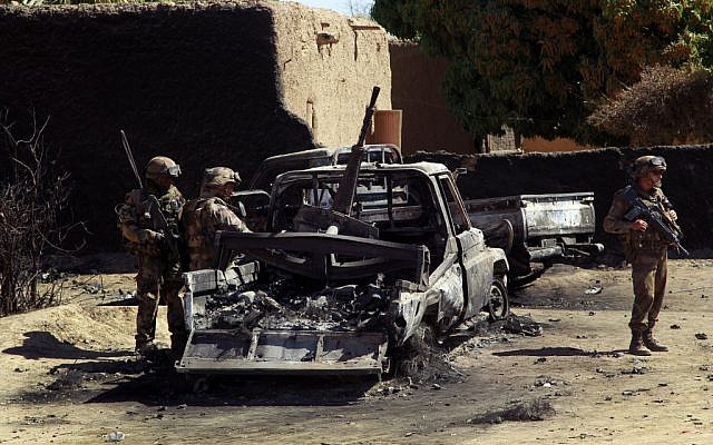 French troops inspect the charred remains of military vehicles used by radical Islamists on the outskirt of Diabaly, Mali on Monday Jan. 21, 2013 (photo credit: AP/Jerome Delay) French troops inspect the charred remains of military vehicles used by radical Islamists on the outskirt of Diabaly, Mali on Monday Jan. 21, 2013 (photo credit: AP/Jerome Delay)