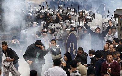 In this file photo from January 28, 2011, Egyptian anti-government protesters clash with riot police in Cairo, Egypt (photo credit: AP/Ben Curtis)