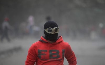 An Egyptian protester part of the Black Bloc, clashes with riot police, not seen, near Tahrir Square, Cairo, Egypt, Monday, Jan. 28, 2013 (photo credit: AP/Khalil Hamra)