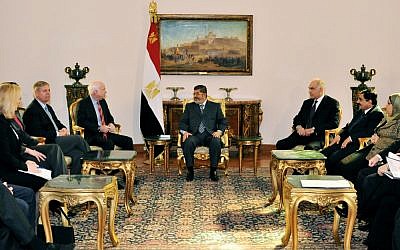 Egyptian President Mohammed Morsi (center) meets with Republican Sen. John McCain (center left) at the Presidential Palace in Cairo on Wednesday, January 16, 2013. (photo credit: AP/Egyptian Presidency)