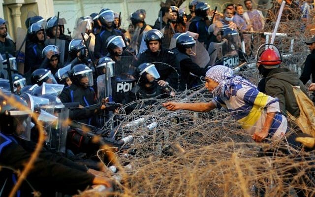 An Egyptian protester talks to anti-riot soldiers during a protest in front of the presidential palace in Cairo, Egypt, Friday, Jan. 25 (photo credit: AP/Amr Nabil)