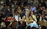 Pope Tawadros II, the 118th pope of the Coptic Church of Egypt, is greeted by Egyptian Christians as he prepares to lead a midnight Mass at St. Mark's Cathedral in Cairo, Egypt, in January 2013 (AP/Amr Nabil)