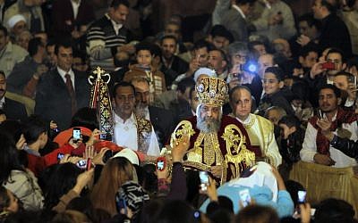 Pope Tawadros II, the 118th pope of the Coptic Church of Egypt, is greeted by Egyptian Christians as he prepares to lead a midnight Mass at St. Mark's Cathedral in Cairo, Egypt, in January 2013 (AP/Amr Nabil)