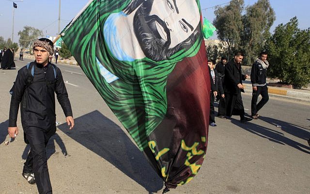 Shiite pilgrims march on their way to Karbala for Arbaeen in Baghdad, Iraq, Monday, Dec. 31, 2012 (photo credit: AP/Karim Kadim) Shiite pilgrims march on their way to Karbala for Arbaeen in Baghdad, Iraq, Monday, Dec. 31, 2012 (photo credit: AP/Karim Kadim)