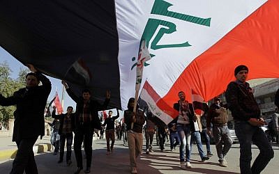 Shiite protesters take to the streets of Baghdad, Iraq, on Saturday to show support for Prime Minister Nouri al-Maliki's government (photo credit: AP/Khalid Mohammed)