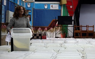 A member of the Jordanian Independent Electoral Commission carries a polling box to be distributed to the polling stations, one day before the designated date of the Jordanian parliamentary elections, in Amman, Jordan, Tuesday, Jan. 22, 2013 (photo credit: AP/Mohammad Hannon)