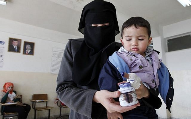 A Jordanian woman inks her finger after casting her ballot inside a polling station in Amman, Jordan, Wednesday, Jan. 23, 2013 (photo credit: Mohammad Hannon/AP) A Jordanian woman inks her finger after casting her ballot inside a polling station in Amman, Jordan, Wednesday, Jan. 23, 2013 (photo credit: Mohammad Hannon/AP)