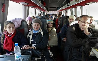 A group of Russian citizens ride a bus shortly after crossing the border from Syria into Lebanon at the Masnaa border crossing Tuesday, Lebanon, Jan. 22, 2013 (photo credit: AP/Bilal Hussein)