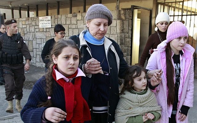 A Russian woman and her children seen shortly after crossing the border from Syria into Lebanon on Tuesday (photo credit: AP/Bilal Hussein)