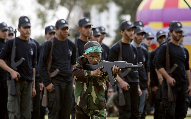 A Palestinian boy pretends to fire a rifle-shaped wooden stick during a graduation ceremony for the first group of school children's military training organized by Hamas in Gaza City, Thursday, Jan. 24 (photo credit: AP/Adel Hana) A Palestinian boy pretends to fire a rifle-shaped wooden stick during a graduation ceremony for the first group of school children's military training organized by Hamas in Gaza City, Thursday, Jan. 24 (photo credit: AP/Adel Hana)